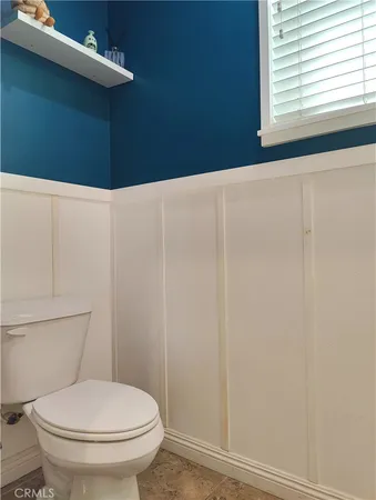 a bathroom with a toilet and a window