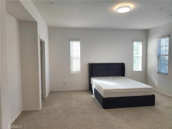 a bedroom with a bed and window