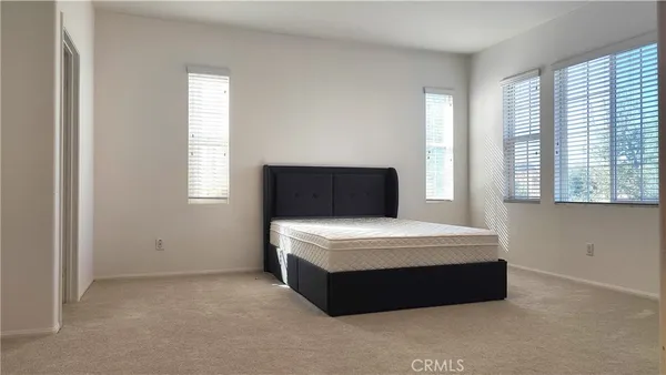 a room with a bed and a window
