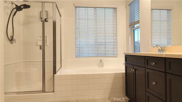 a white toilet sitting next to a white cabinet