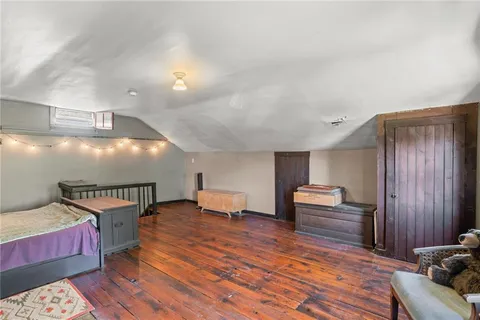 a bedroom with furniture and wooden floor