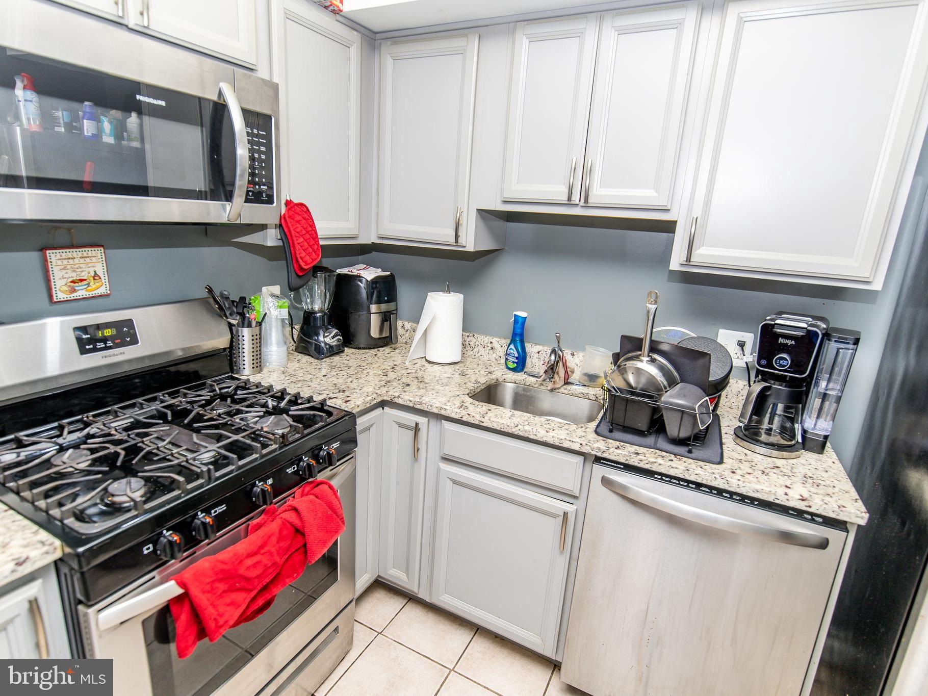 3934 Bel Pre Road, Unit 39342 Silver Spring, MD 20906 - Photo 7 of 30 a kitchen with stainless steel appliances granite countertop a sink stove and cabinets
