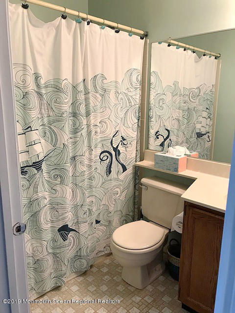 50 Sweet Gum Road Howell, NJ 07731 - Photo 14 of 18 a bathroom with a toilet and a shower curtain