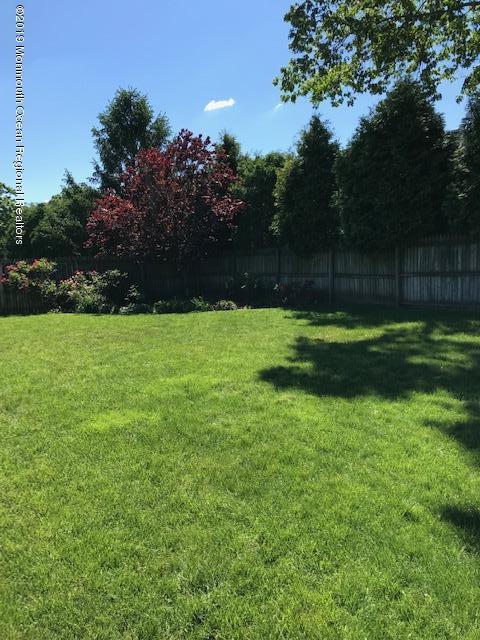 50 Sweet Gum Road Howell, NJ 07731 - Photo 17 of 18 a backyard of a house with lots of green space