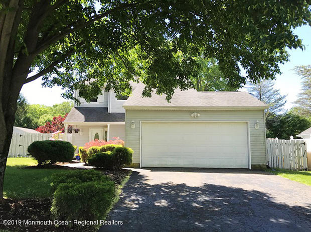 50 Sweet Gum Road Howell, NJ 07731 - Photo 18 of 18 a front view of a house with a yard and garage