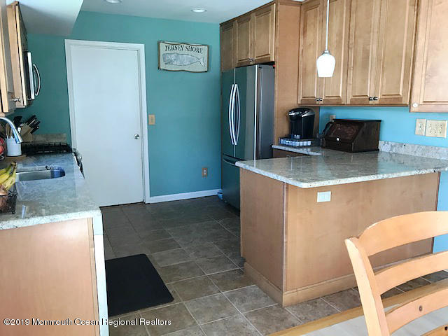 50 Sweet Gum Road Howell, NJ 07731 - Photo 6 of 18 a kitchen with stainless steel appliances granite countertop a refrigerator and a sink