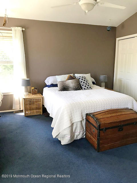 50 Sweet Gum Road Howell, NJ 07731 - Photo 9 of 18 a bedroom with a bed lamp and a window