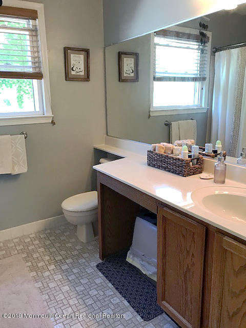 50 Sweet Gum Road Howell, NJ 07731 - Photo 10 of 18 a bathroom with a sink a toilet and window
