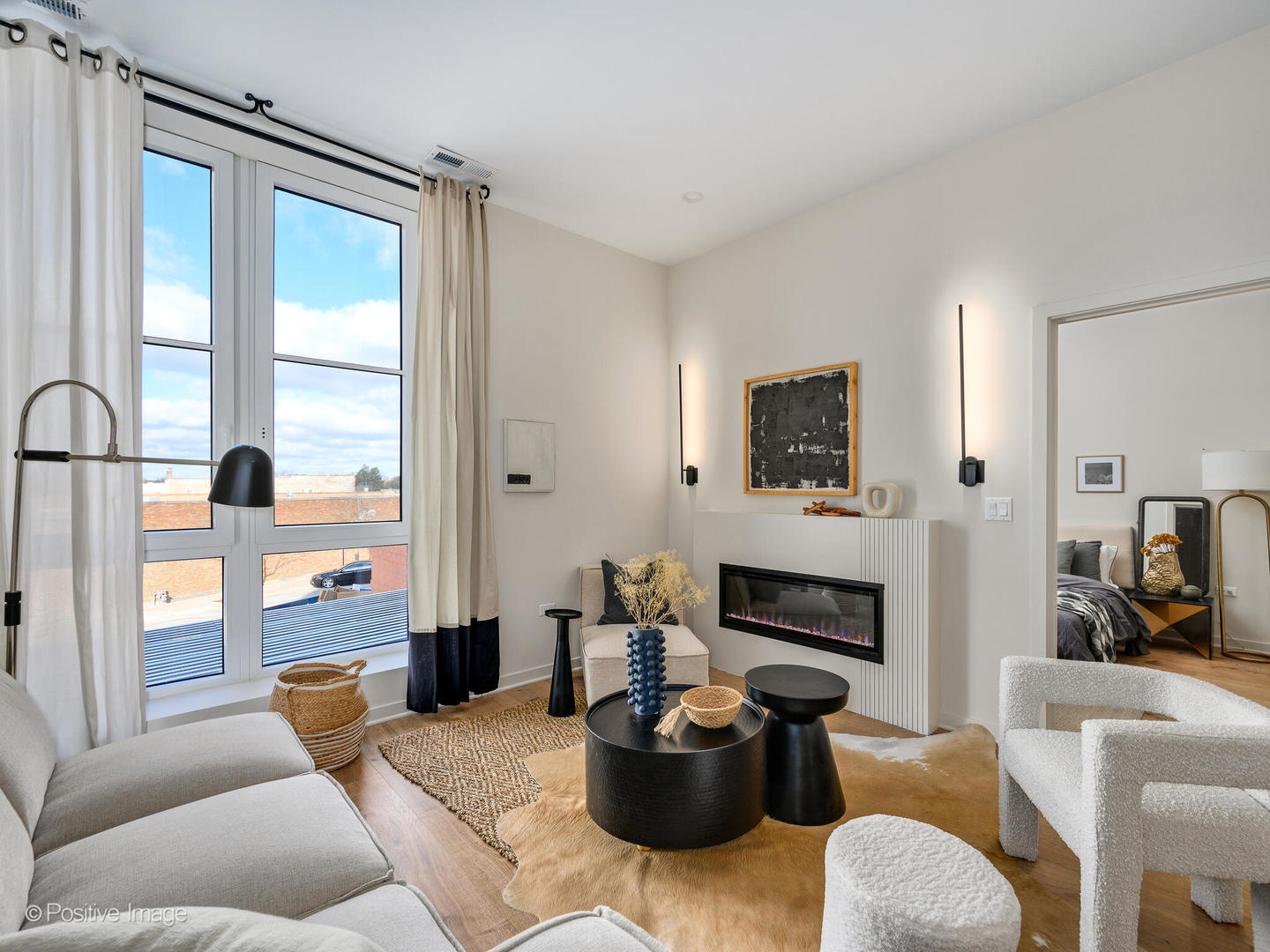 11 West Prospect Avenue, Unit 212 Mount Prospect, IL 60056 - Photo 6 of 34 a living room with furniture a large window and a fireplace