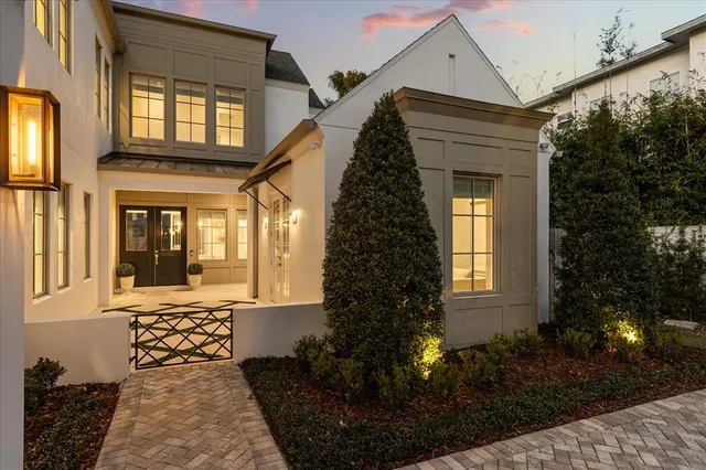 a view of an empty room with a window and a kitchen