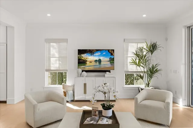 a bathroom with a double vanity sink a large mirror and a bathtub