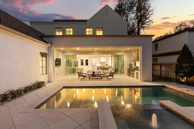 a spacious bedroom with a bed and a lamp