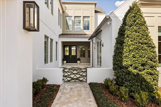 a large kitchen with kitchen island a stove a sink a chimney and a living room view
