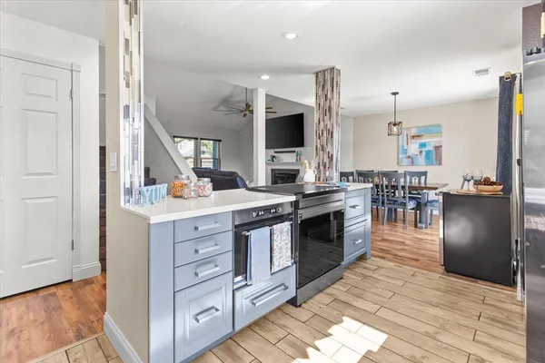 a kitchen with stainless steel appliances kitchen island granite countertop a stove a sink and a refrigerator