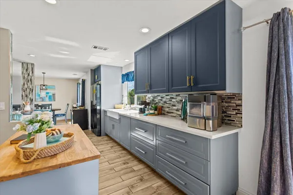 a kitchen with kitchen island granite countertop wooden cabinets and white appliances