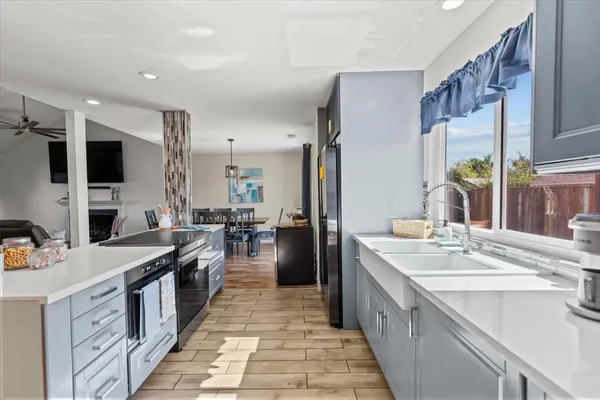 a kitchen with stainless steel appliances a sink stove top oven and cabinets