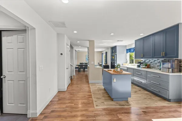 a kitchen with lots of counter top space and center island