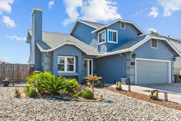 a front view of a house with garden