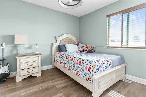 a bedroom with a bed and a window