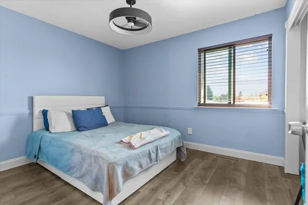 a bedroom with furniture and a window
