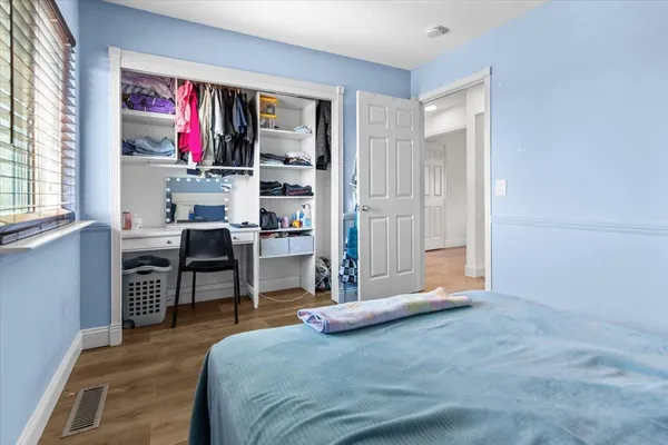 a kitchen that has a lot of cabinets in it and wooden floors