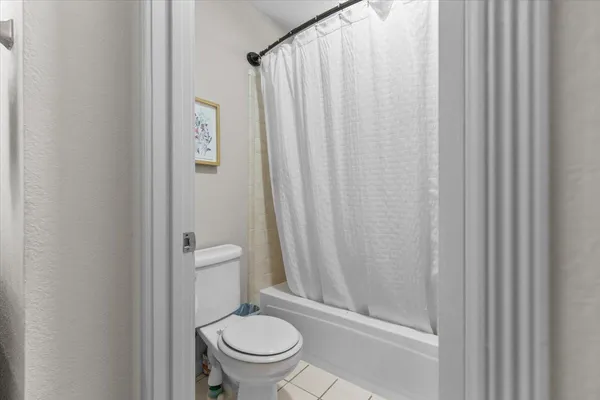 a bathroom with a sink vanity mirror and toilet