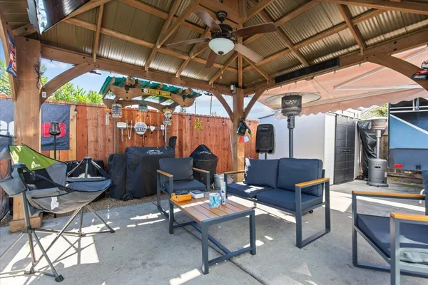 a view of a house with pool fire pit and chairs