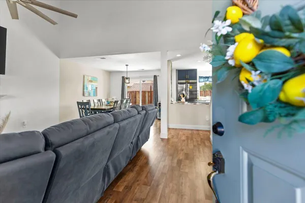 a living room with furniture and wooden floor