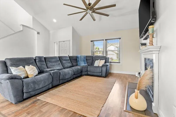 a living room with furniture a fireplace and a flat screen tv