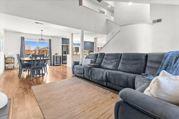 a living room with furniture and wooden floor