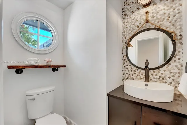 a bathroom with a sink a mirror and a toilet