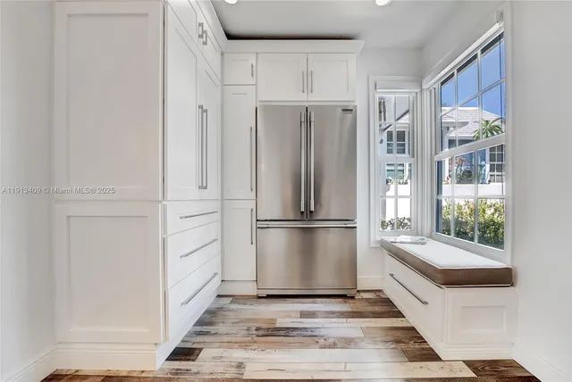 a kitchen with white cabinets and white appliances