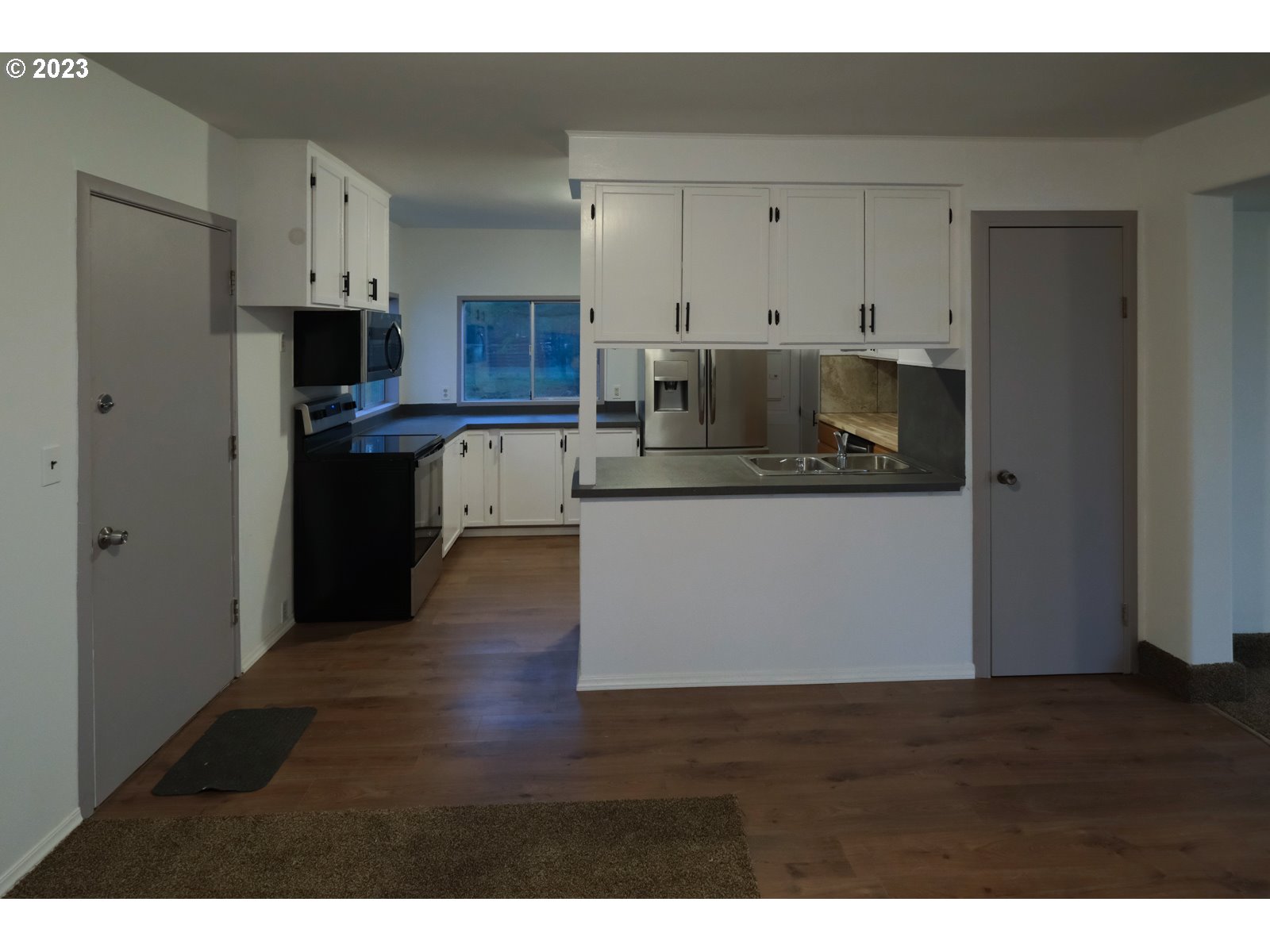 122 Talbott Road Salkum, WA 98582 - Photo 22 of 32 a kitchen with stainless steel appliances granite countertop a refrigerator a stove top oven a sink and dishwasher with wooden floor