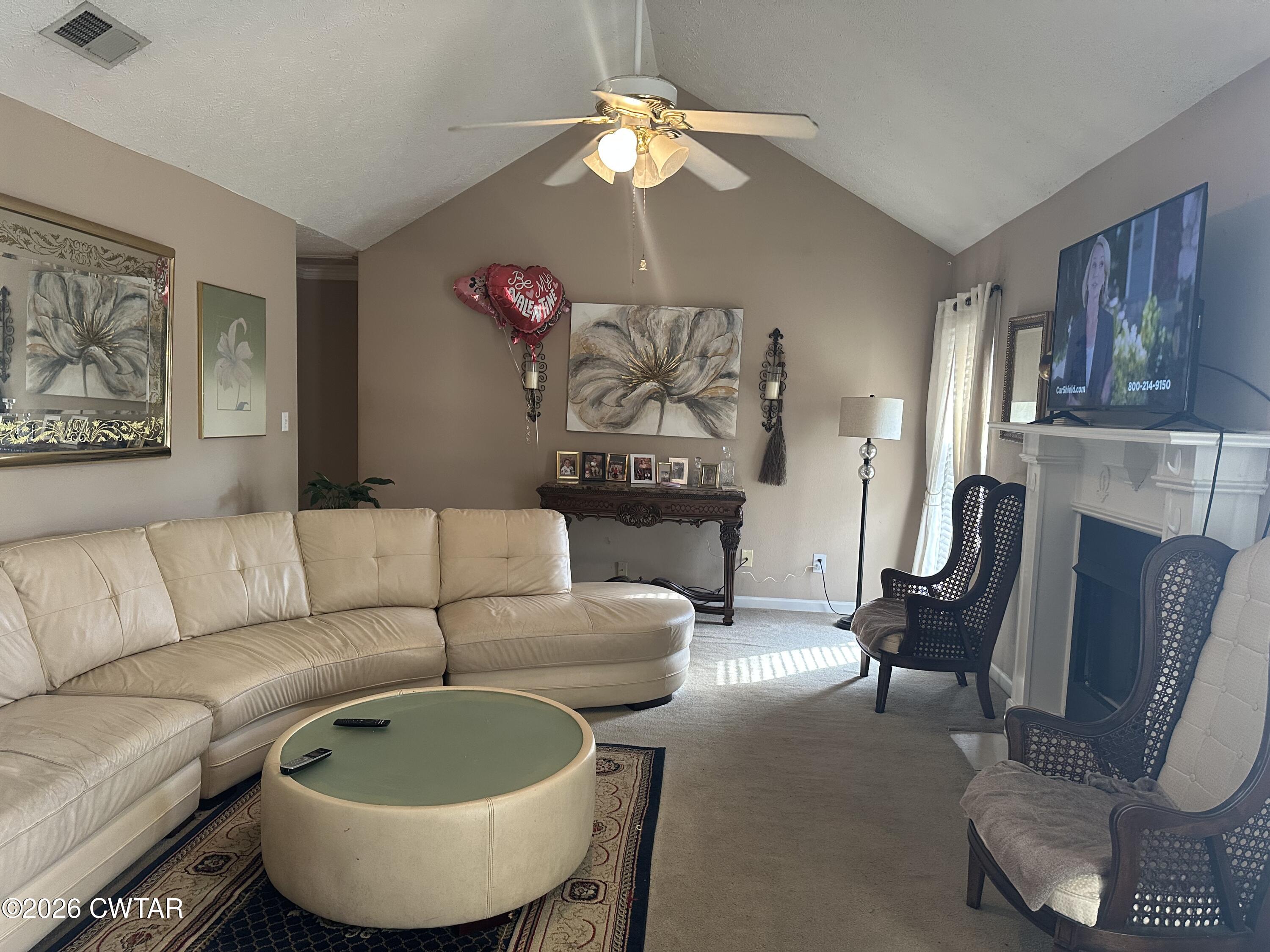 204 Rooker Drive Jackson, TN 38305 - Photo 2 of 8 a living room with furniture a couch and a chandelier