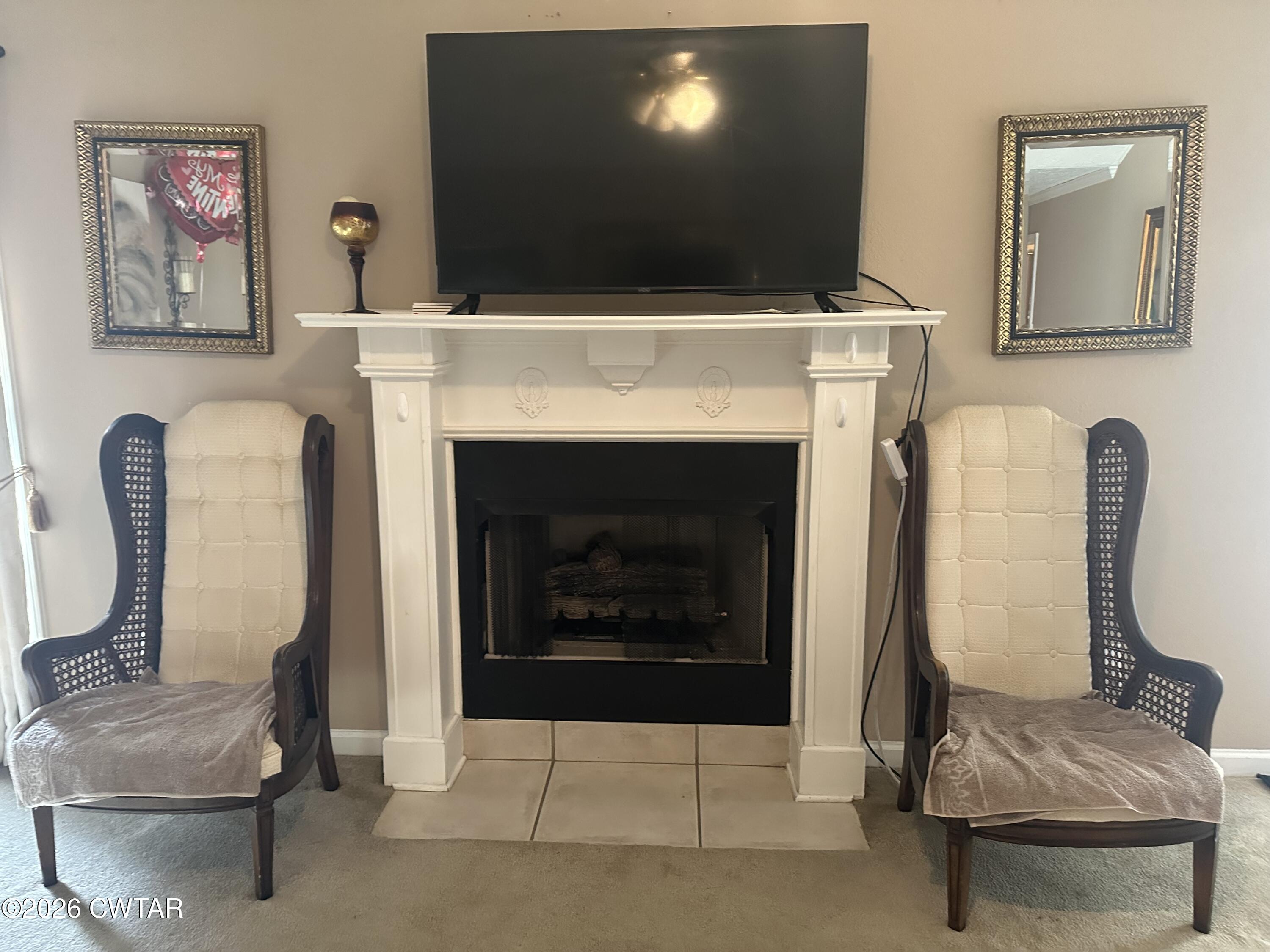 204 Rooker Drive Jackson, TN 38305 - Photo 3 of 8 a living room with furniture and a fireplace