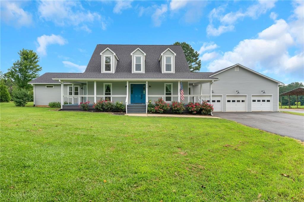 a front view of house with yard and green space