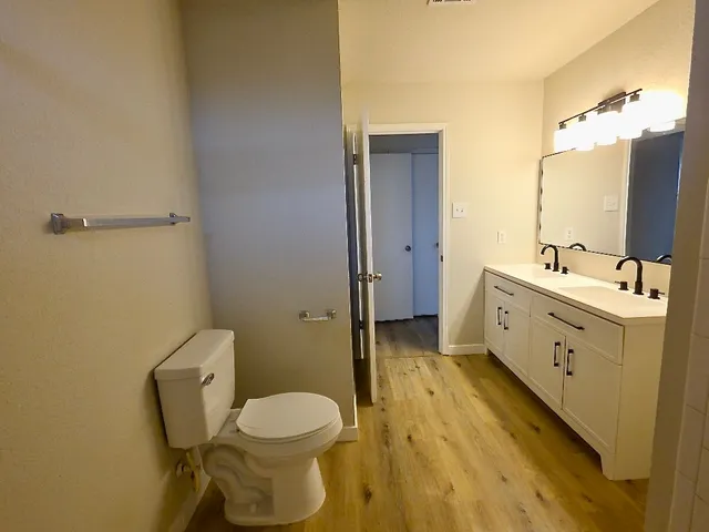 a bathroom with a toilet sink and mirror
