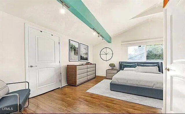 a bedroom with a bed mirror and window