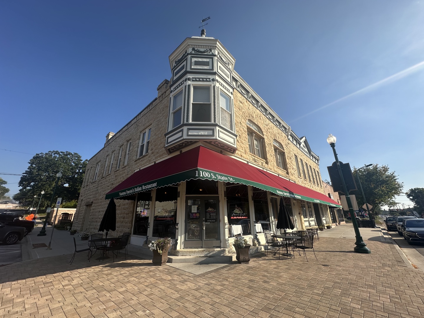 a front view of a building with sitting area