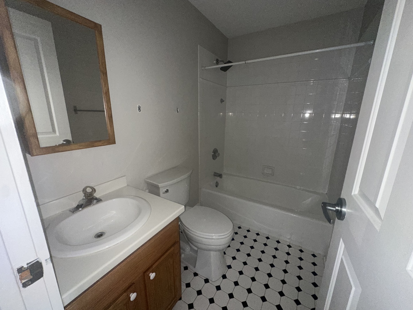 105 East 11th Street, Unit 2 Lockport, IL 60441 - Photo 11 of 14 a bathroom with a sink a toilet a mirror a vanity and shower