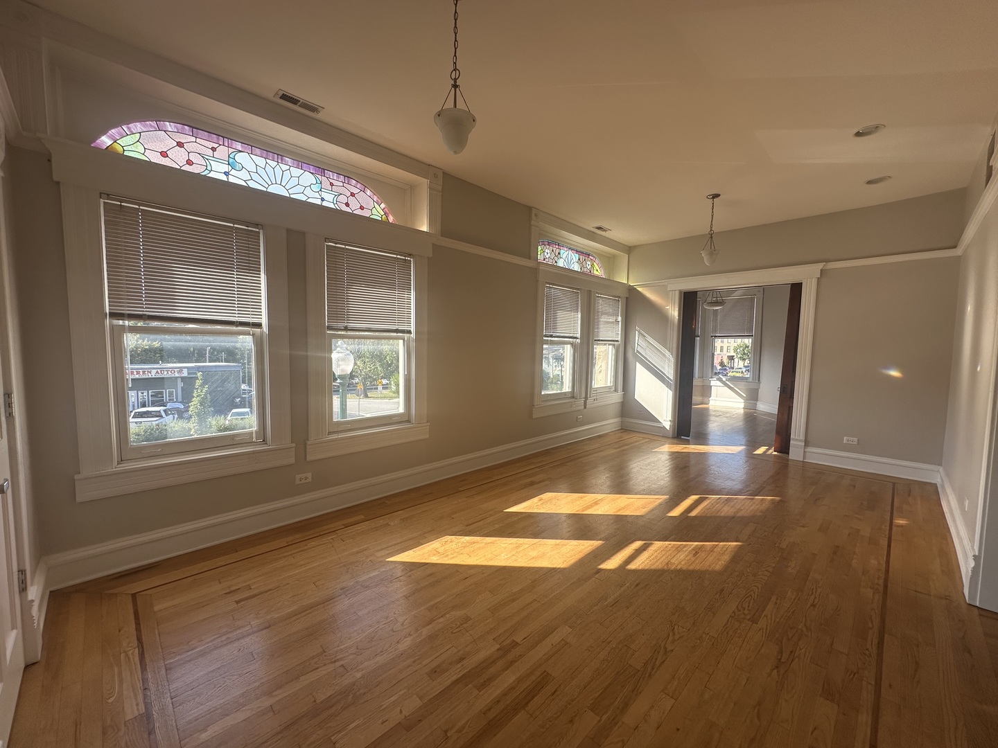 105 East 11th Street, Unit 2 Lockport, IL 60441 - Photo 3 of 14 a view of an empty room with window and wooden floor