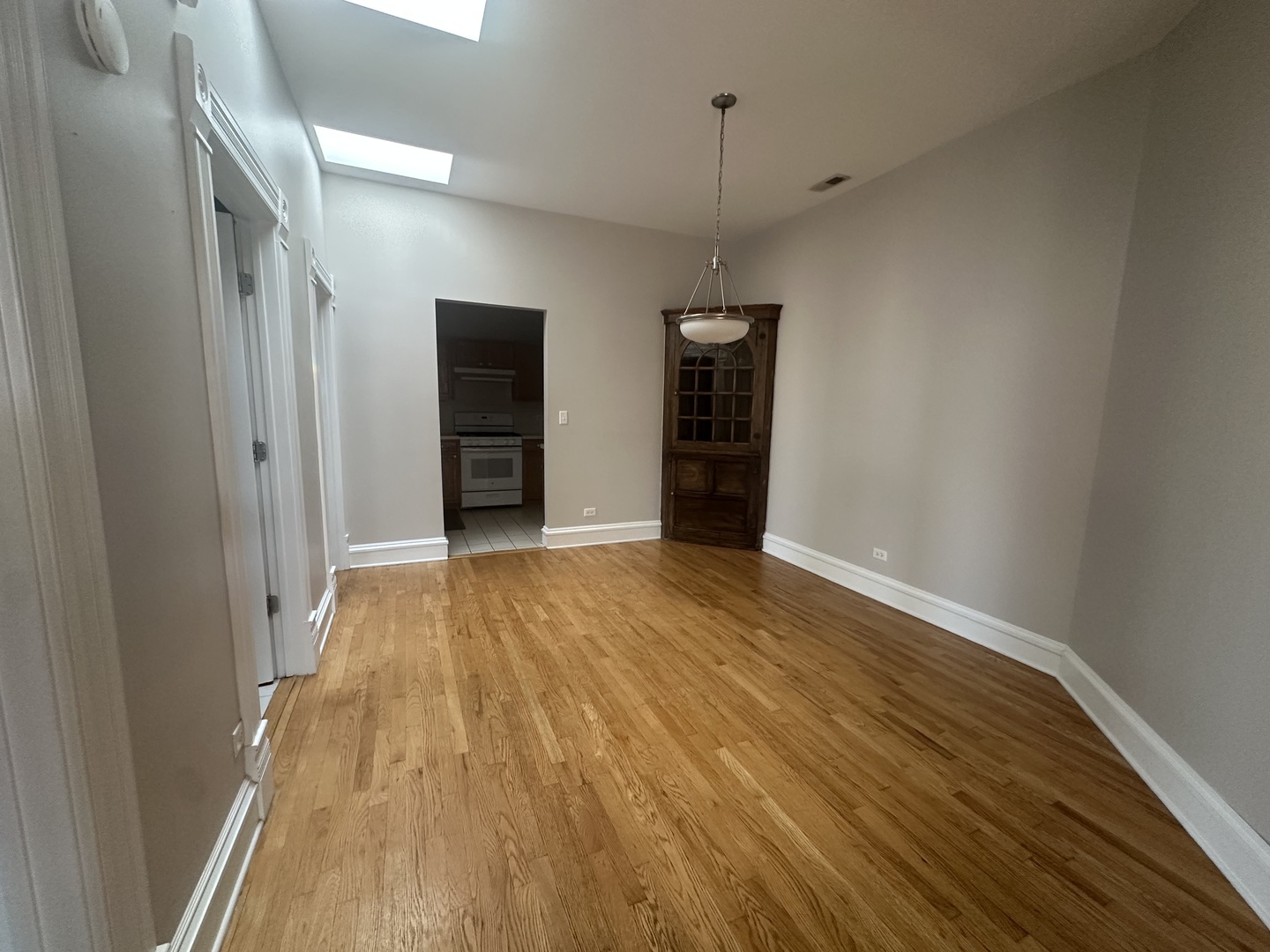 105 East 11th Street, Unit 2 Lockport, IL 60441 - Photo 5 of 14 wooden floor in an empty room with a window