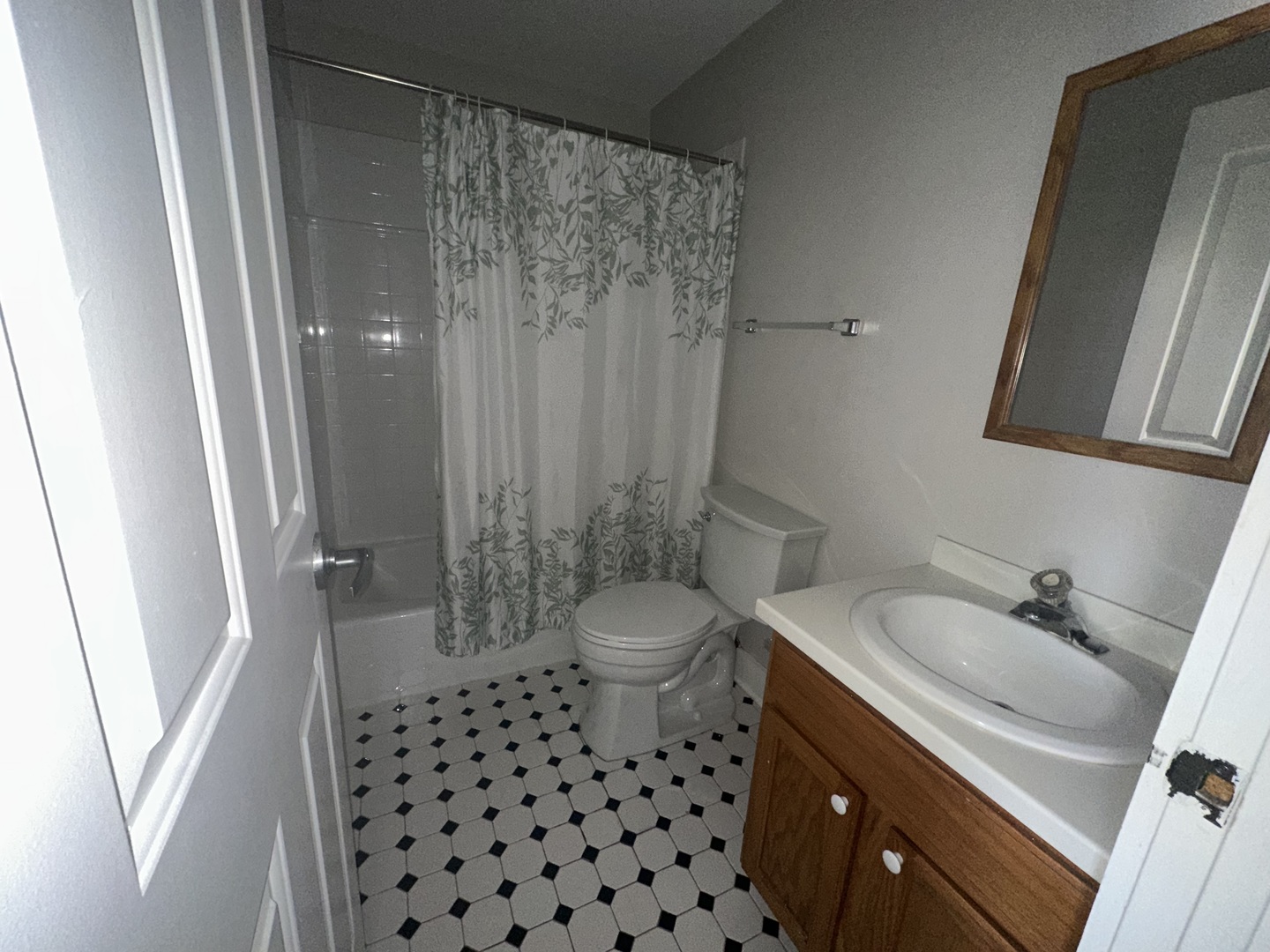 105 East 11th Street, Unit 2 Lockport, IL 60441 - Photo 9 of 14 a bathroom with a sink a toilet a mirror and shower