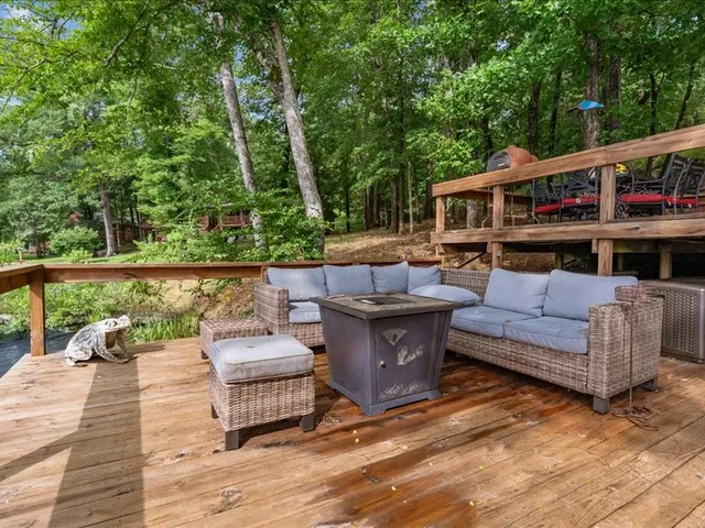 a view of a patio with couches chairs and a wooden floor