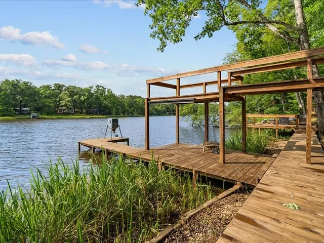 a view of a patio with chairs next to a yard