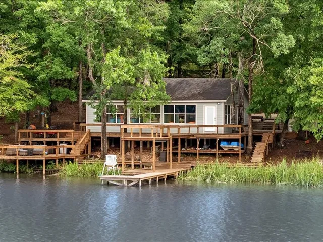 an aerial view of a house with swimming pool and deck