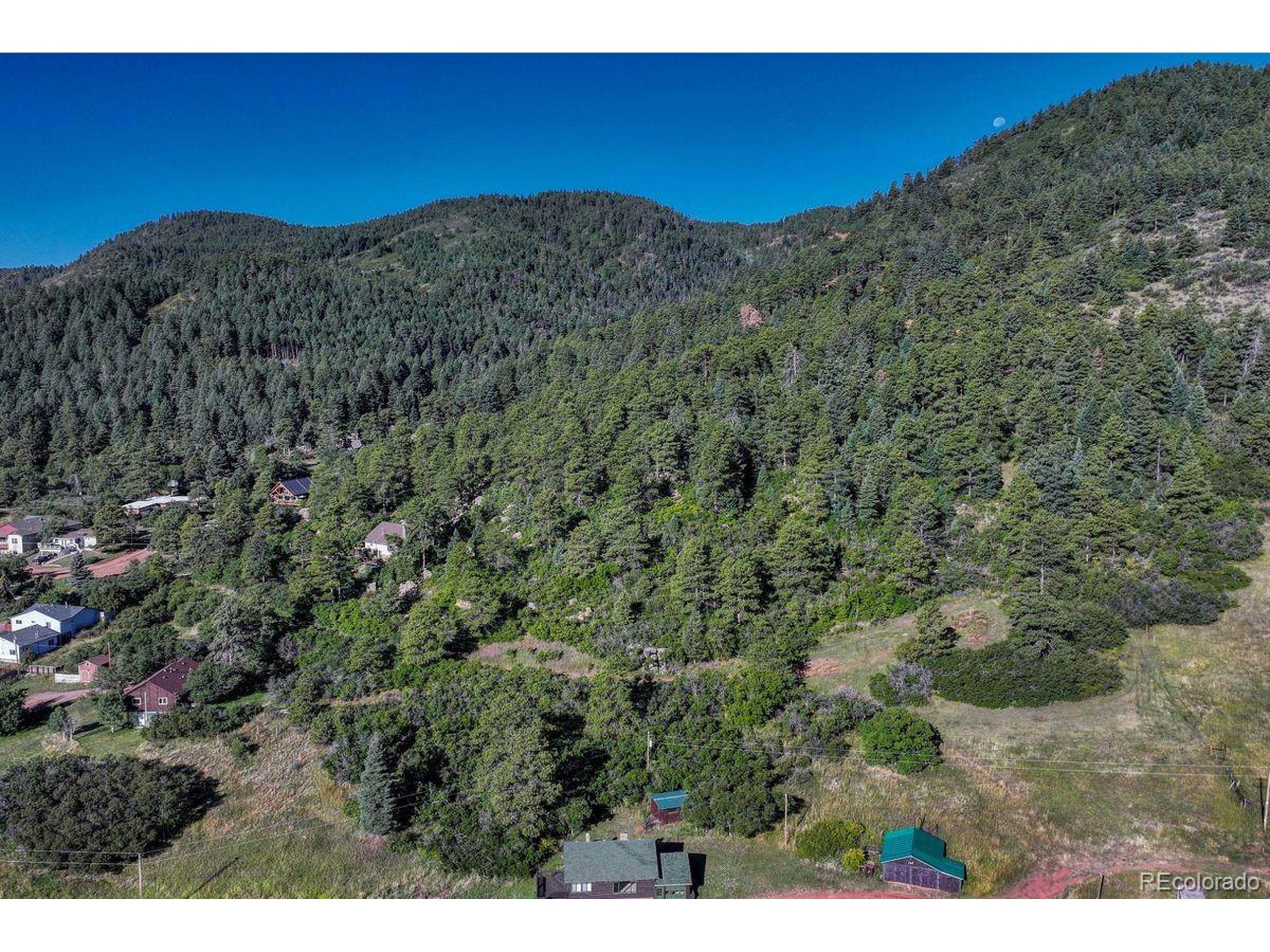 0 Columbine Road Palmer Lake, CO 80133 - Photo 24 of 37 a view of a large building with a mountain in the background
