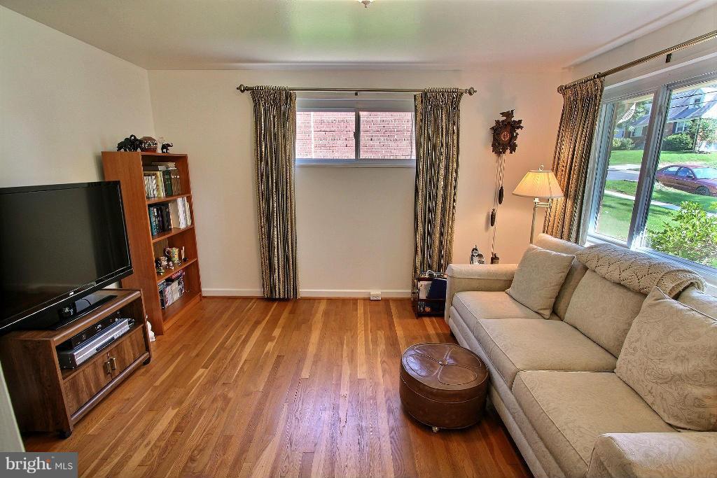12902 Goodhill Road Silver Spring, MD 20906 - Photo 6 of 20 a living room with furniture and a flat screen tv