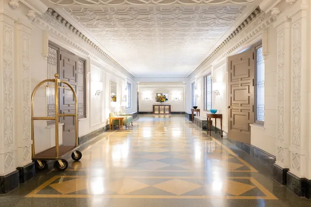 a lobby with furniture and floor to ceiling windows