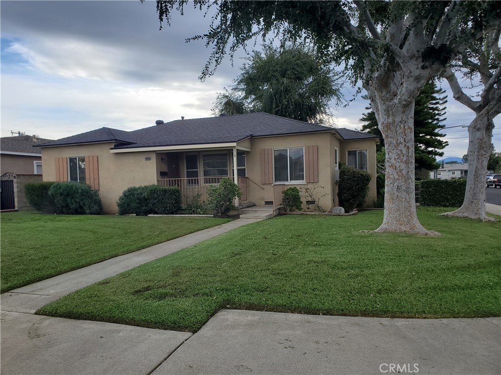 a front view of house with yard and green space